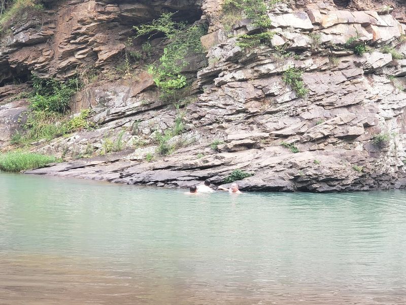 Crystal Clear Water Beneath Towering Rock