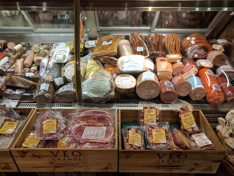 A Deli Case Packed With Meats And Cheeses