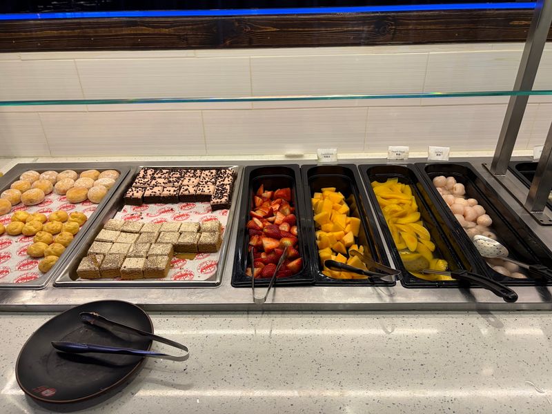 A Food Bar Stacked With Crab Legs And Fruit