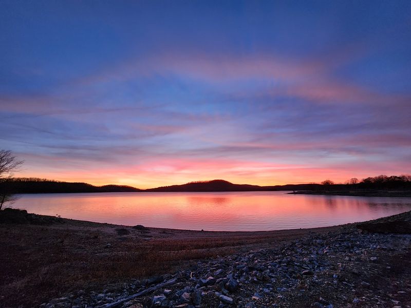 A Glimpse Across The Mountain Lake