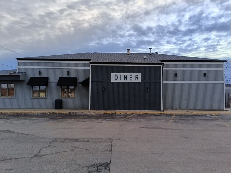 A Gray Building With One Bold Word On The Sign