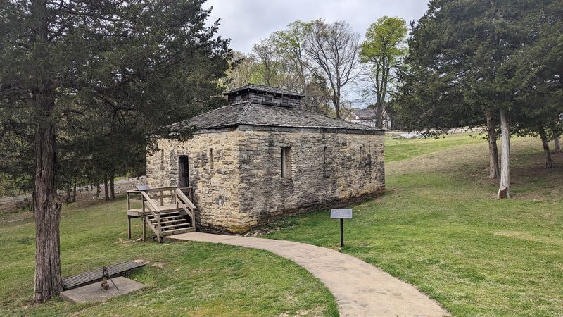 Quiet Grounds Framed By Weather, Grass, And Memory