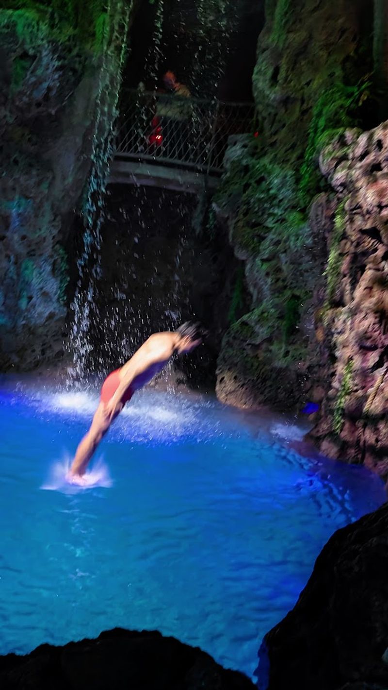 Cliff Divers And A Thirty-Foot Waterfall Inside A Restaurant