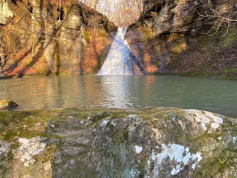 A Shaded Grotto Beneath The Falls