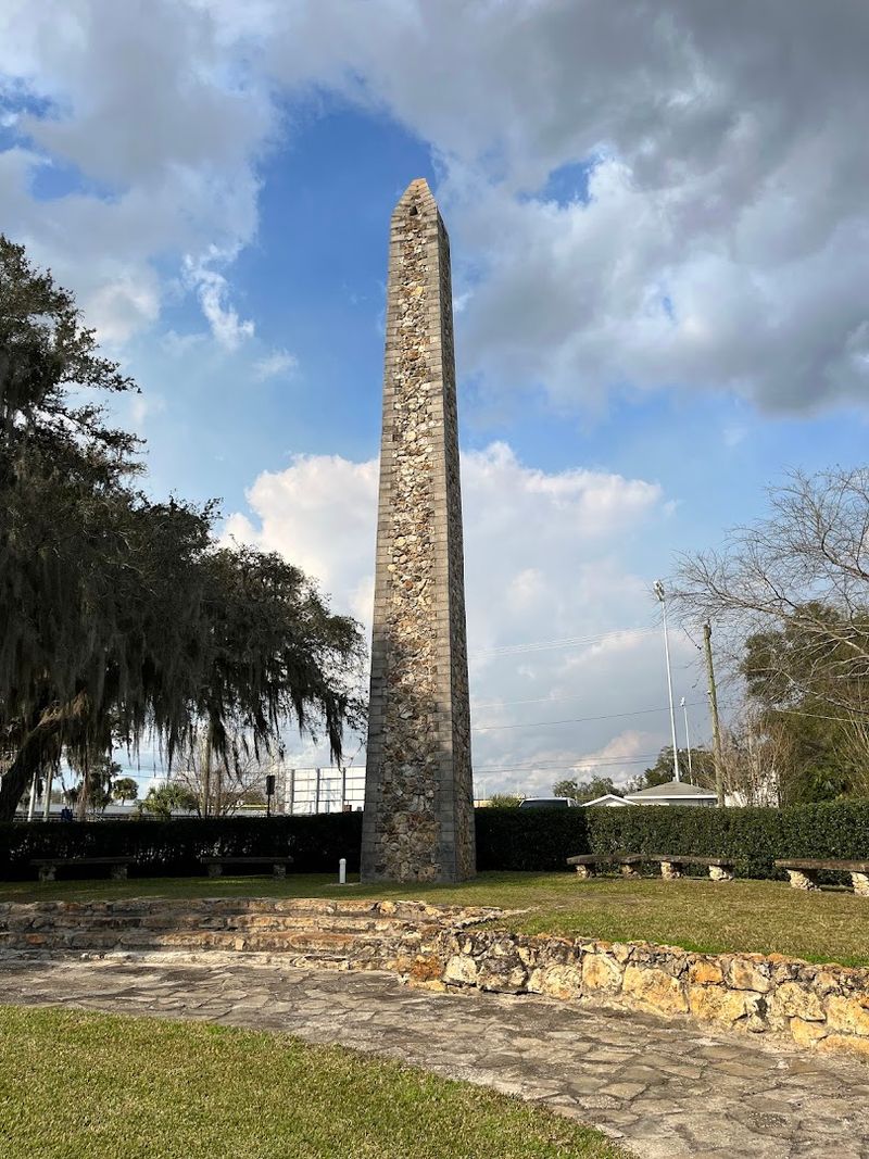 A Striking Historic Obelisk Standing Quietly Among The Trees