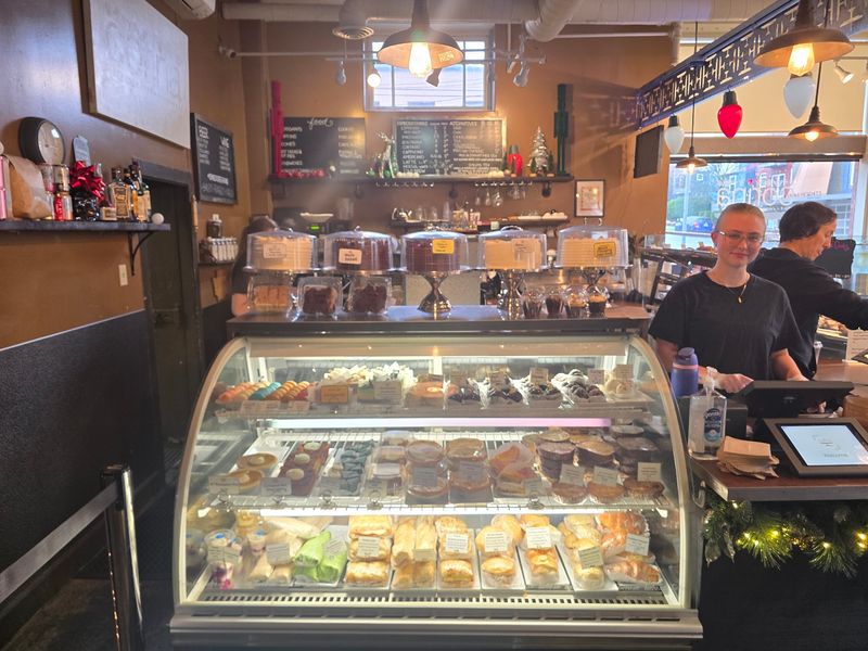 An Artsy Room With Friendly Faces Behind The Counter