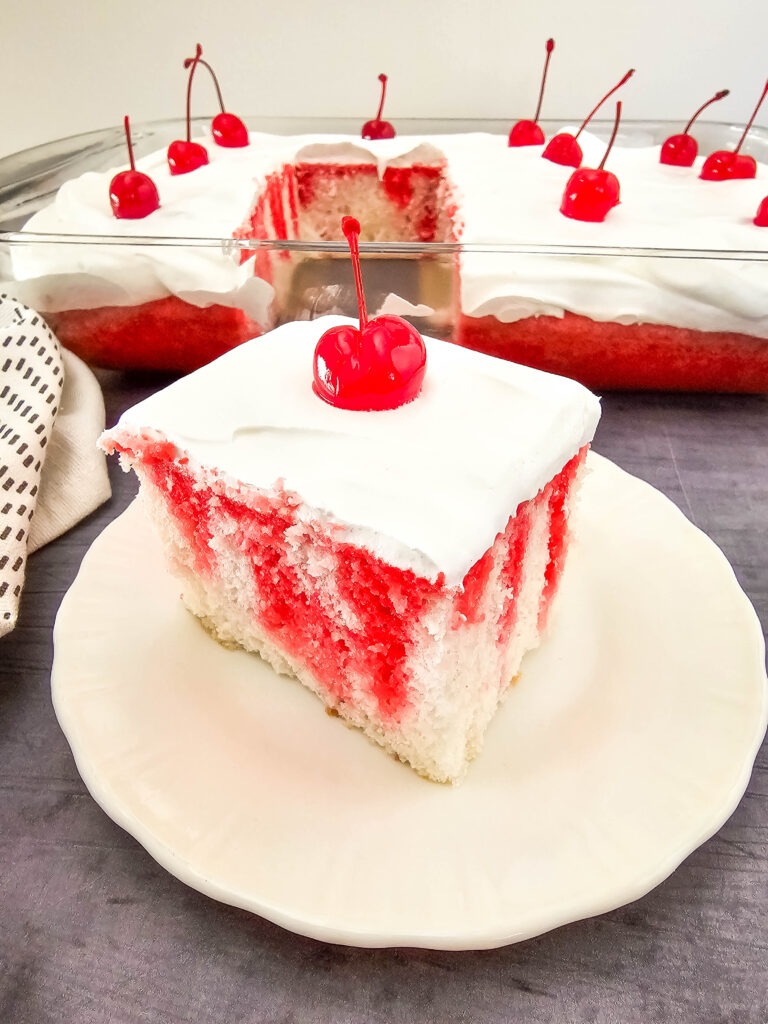 You will need the following items to make this recipe:

Measuring cups, large bowl and mixer or stand mixer, silicone spatula, 9x13 cake pan, skewer sticks or large fork, medium saucepan, whisk

Ingredients:

●	1 box (13.25 oz) white cake mix, plus ingredients listed on the box (ours called for 1 ¼ cups water, ½ cup oil, 4 eggs whites)
●	3 oz box cherry Jell-O
●	1 cup boiling water
●	1 cup cold water
●	8 oz whipped topping 
●	12 maraschino cherries

Directions:

1.	Preheat the oven to 350 degrees, and grease a 9x13 inch baking dish.
2.	In a large bowl, beat the cake mix, water, oil, and egg whites for 3 minutes.
3.	Bake for 35 minutes, or until a toothpick inserted into the center of the cake comes out clean.
4.	Remove the cake from the oven, and allow to cool for 5-10 minutes.
5.	Poke holes all over the cake every ½ inch or so using a skewer stick or large fork.
6.	Prepare the jello by bringing 1 cup of water to a boil, and stirring in the gelatin until dissolved. Stir in another 1 cup of water, and whisk for 3 minutes.
7.	Slowly pour the prepared liquid over the cake, allowing it to absorb into the holes.
8.	Refrigerate for 4 hours. 
9.	To serve, top with whipped topping and maraschino cherries.


