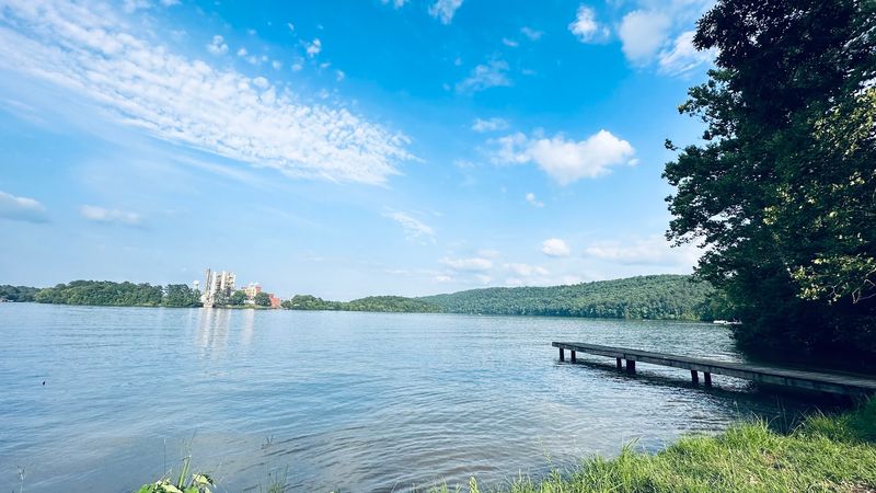 Sandy Lakeside Escape Surrounded By Forested Mountain Views