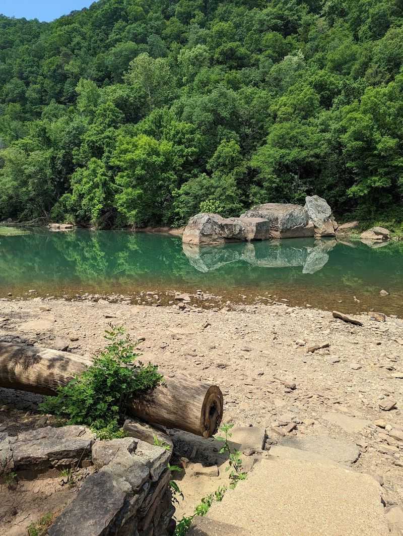 A Natural Pool Carved Between Forested Bluffs