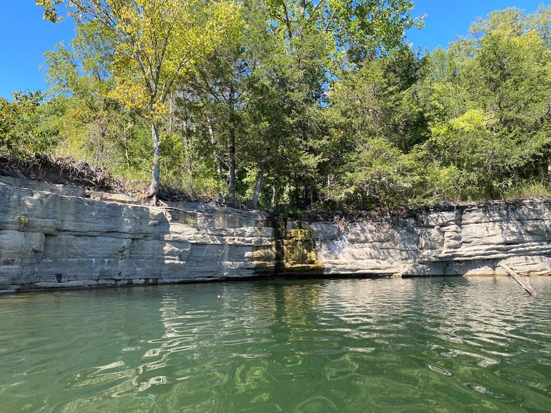 Emerald Water Beneath Weathered Bluffs
