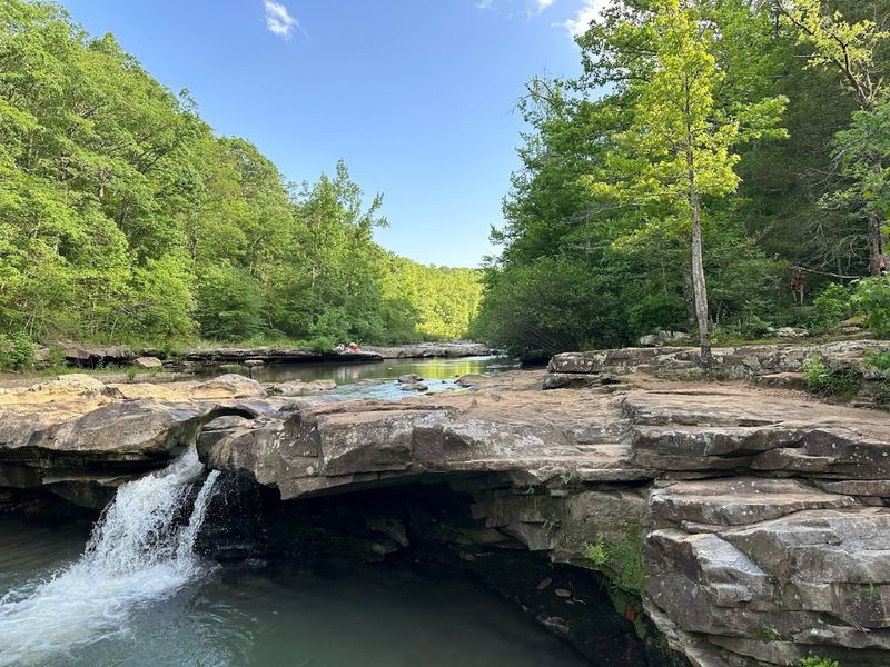 Sunlight Dancing Across Stone And Flowing Water