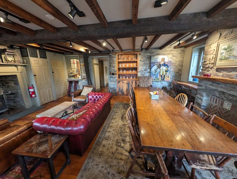 The Interior Has Multiple Rooms With Unique Decor, A Fireplace, And Old-World Charm