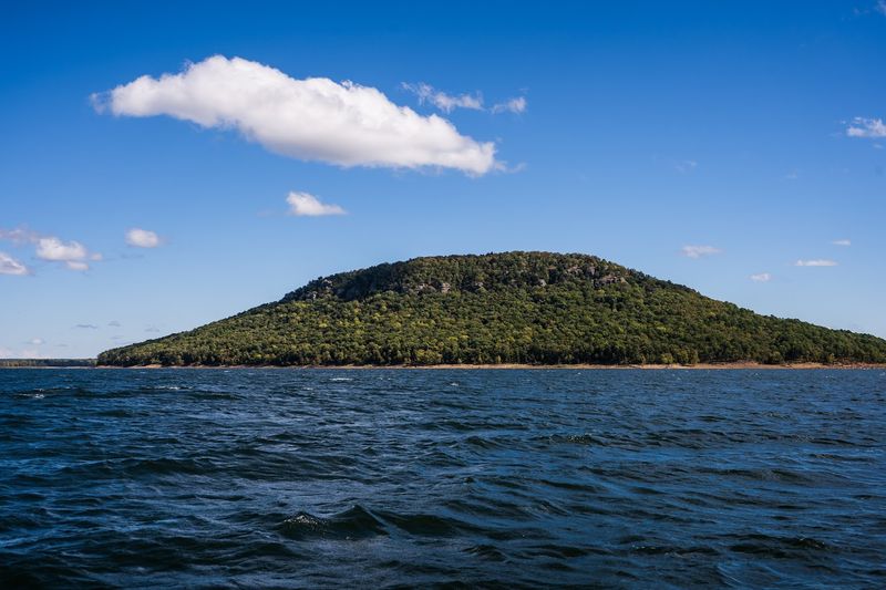 Island Summit Rising From Blue Water