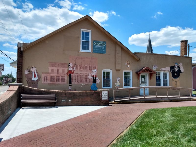 Murals, Cutouts, And A Water Tower With A Famous Face
