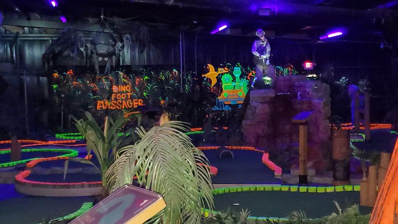 Blacklight Mini Golf With Dinosaur Theming
