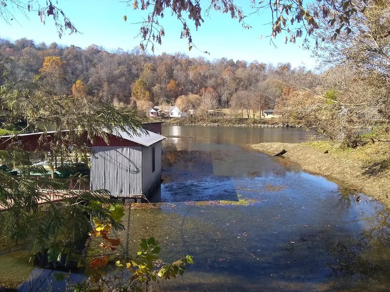 Steady River Flow Beneath Weathered Boards