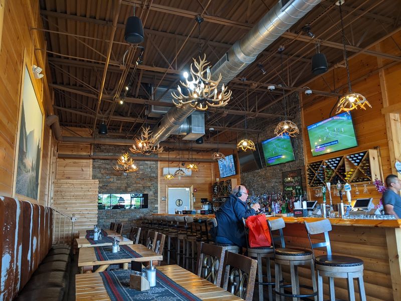 Rustic Wood, Antler Chandeliers, and a Cozy Glow