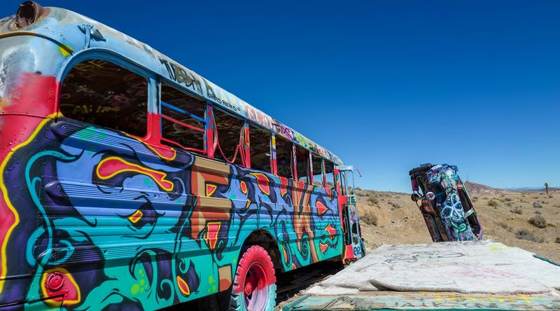School Buses Standing Skyward In The Desert