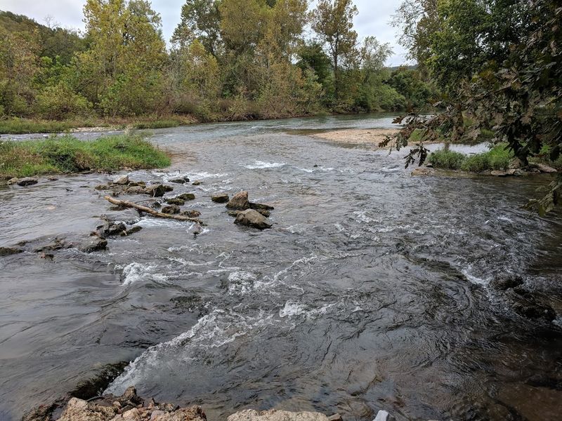Sunset Reflections Rippling Across Glassy Water Trails