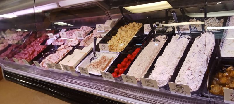 Deli Counter Loaded with Homemade Salads and Sliced Perfection