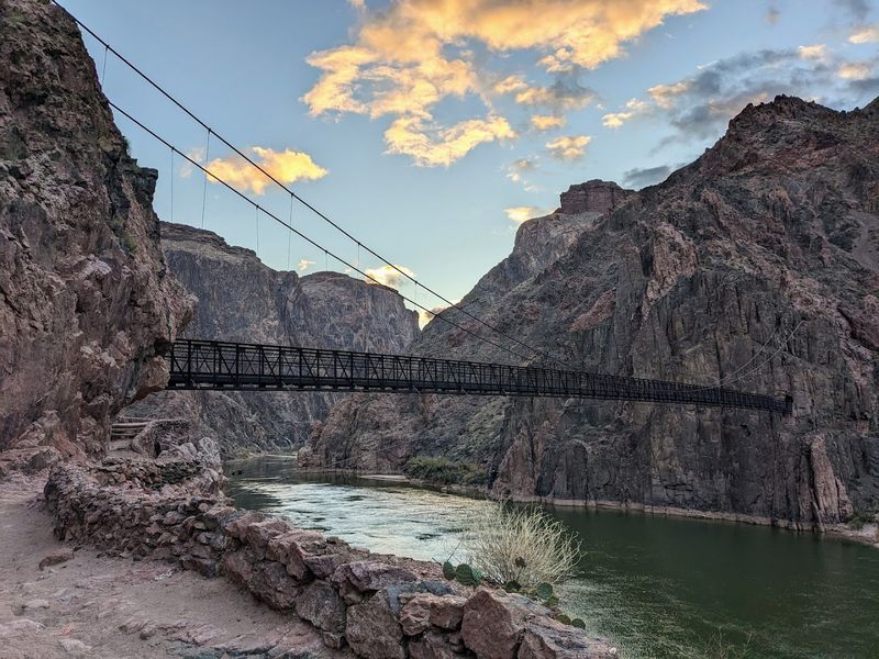 The Black Suspension Bridge At The Bottom