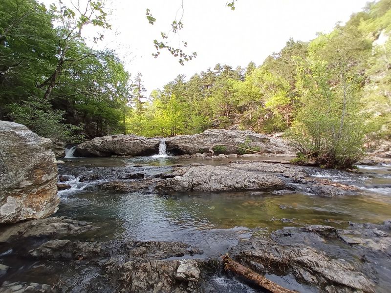 Sunlight Dancing Across Still Water And Stone