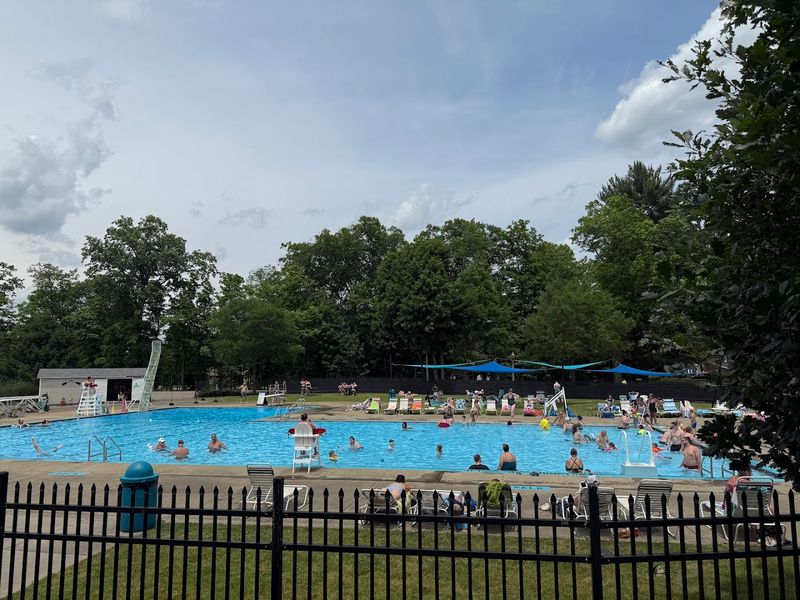The Pool With A Rock Wall And A View