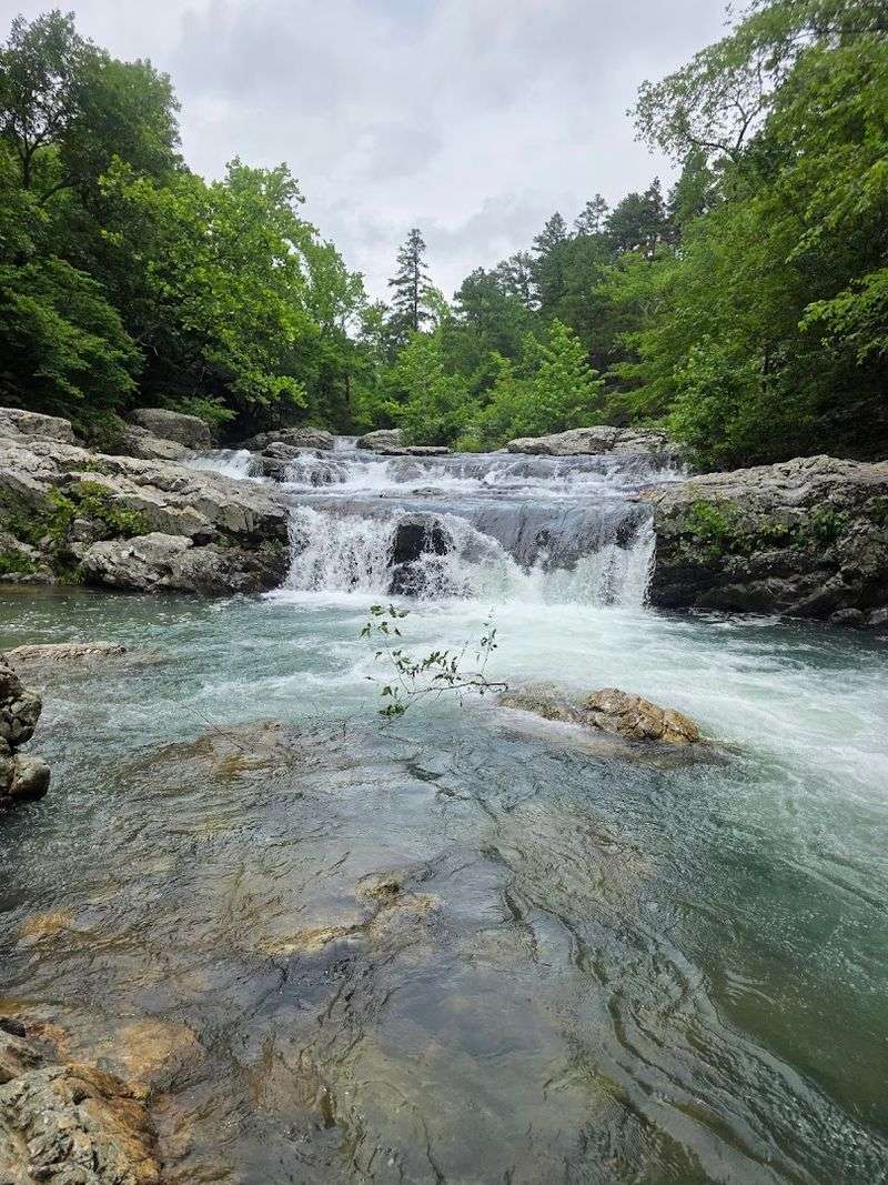 A Cascade Hidden Between Rock And Wilderness