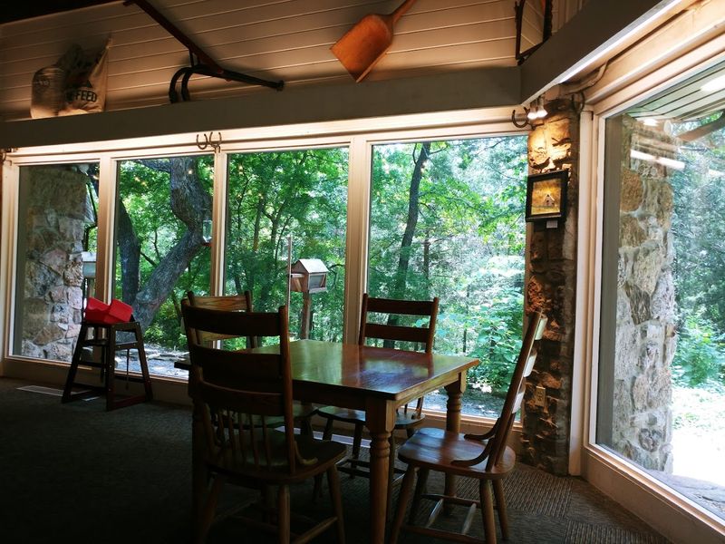 Hidden Woodland Dining Room Framed By Glass