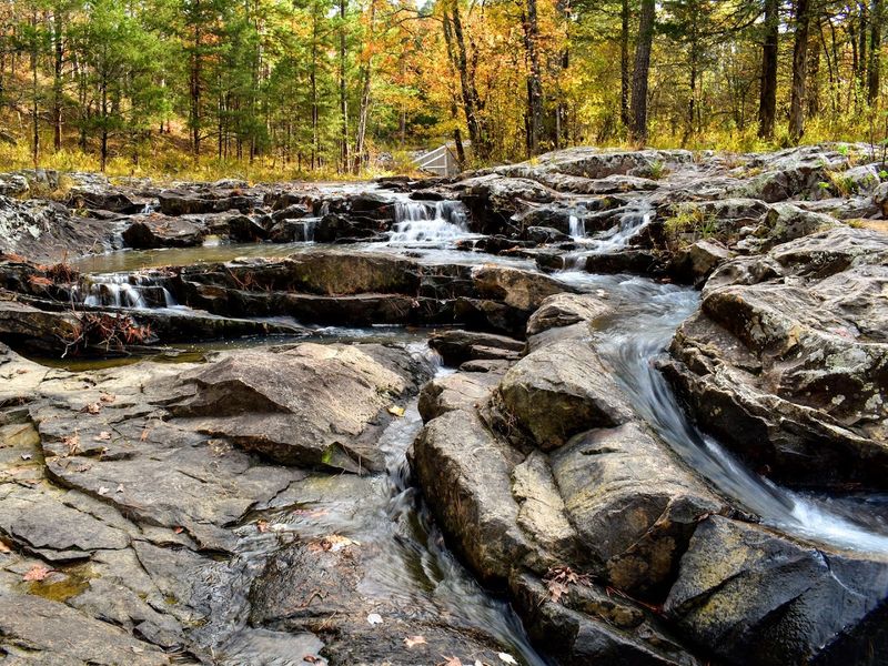 Sheer Bluff Walls Framing A Crystal Clear Plunge Pool