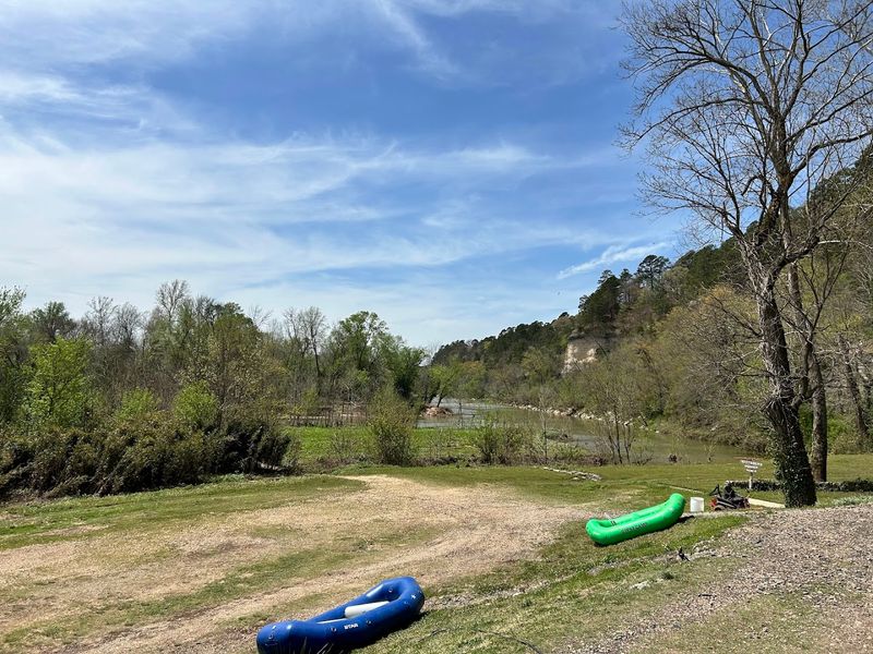Canvas Tents Set Along A Wild Riverbank