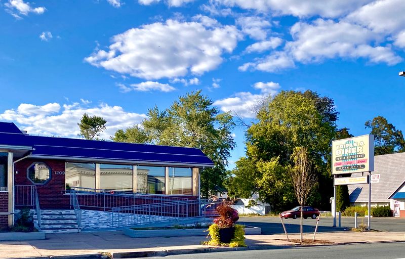 Neon Sign Casting A Glow On Main Street