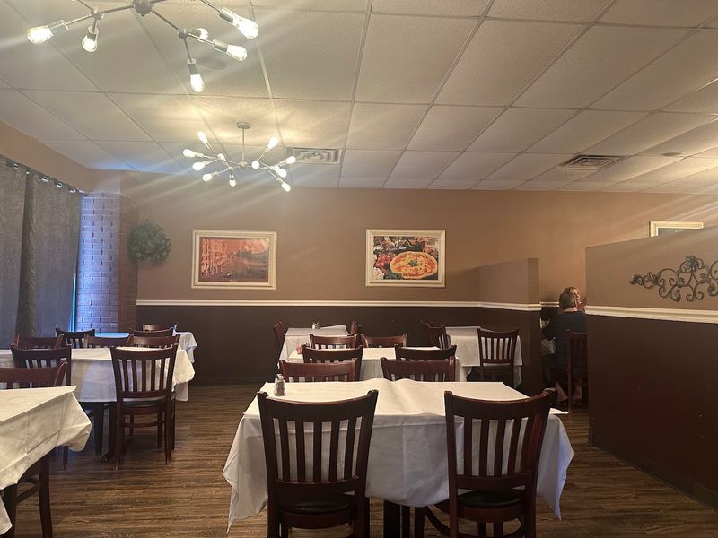 Chandeliers And Greenery Creating A Warm Dining Atmosphere