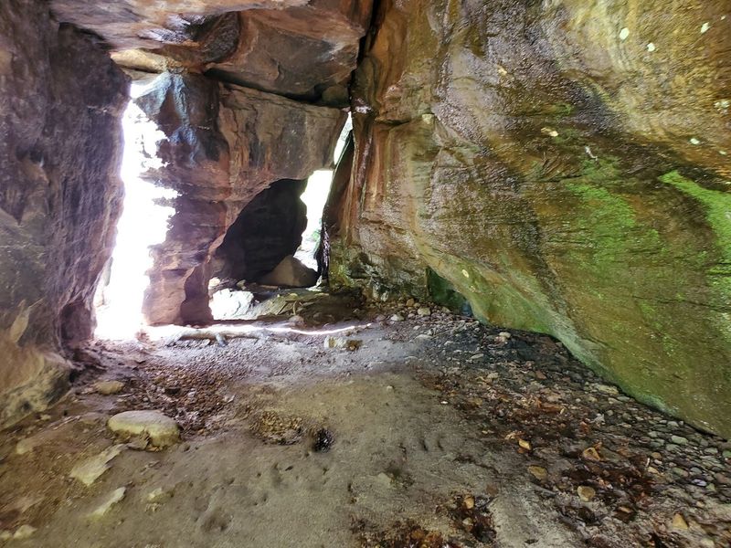 A Cool Shaded Rock Shelter Beneath The Cliff Overhang