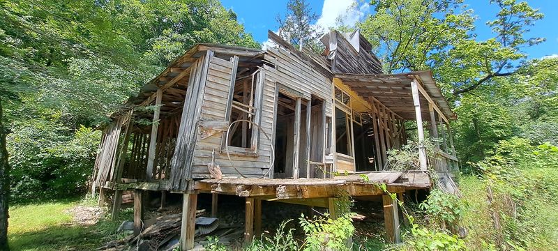 Weathered Cabins Beneath The Bluffs
