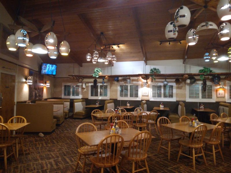 Wood Paneling, Cozy Booths, And A Retro Glow