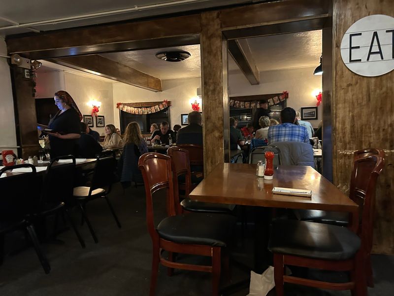 Wood, Red Chairs, And String Lights Set A Cozy Scene