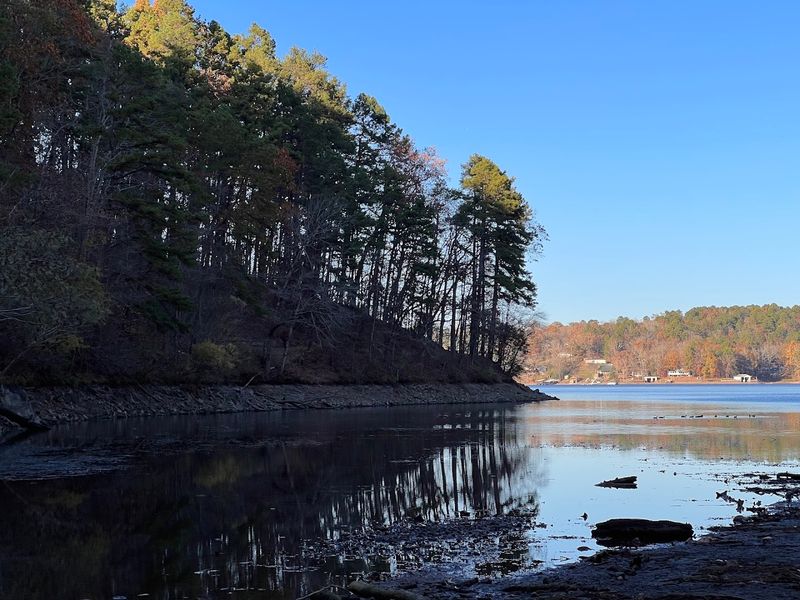 Serene Lake Setting Surrounded By Forested Mountain Ridges