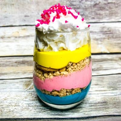 These unicorn parfaits are layers of brightly colored pink, purple and yellow pudding with crushed vanilla cookies in between the decadent layers.