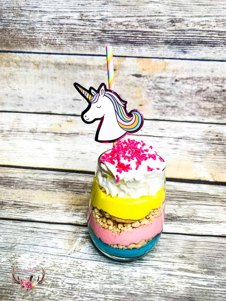 These unicorn parfaits are layers of brightly colored pink, purple and yellow pudding with crushed vanilla cookies in between the decadent layers.