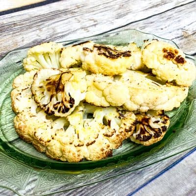 I think I may have just made the best roasted cauliflower ever! The cauliflower is soft and sweet with caramelized edges – It is so good, I may or may not have eaten the entire head of cauliflower myself.