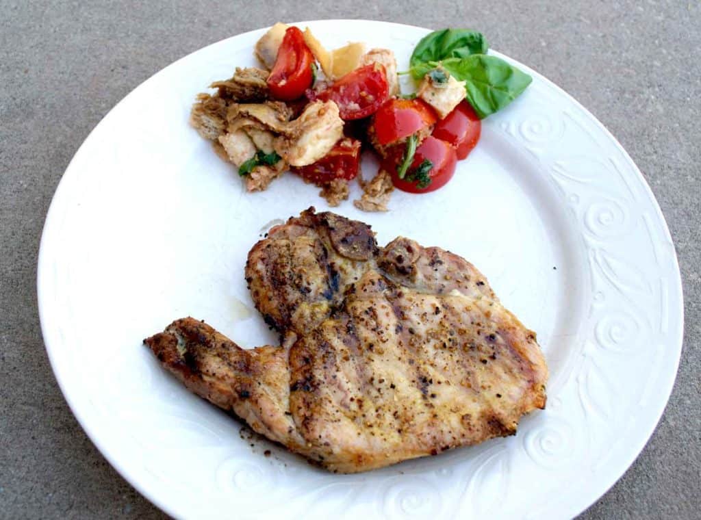 An easy and delicious tomato panzanella salad recipe. A perfect pairing with Smithfield All Natural Pork Chops for BBQ season this Spring.