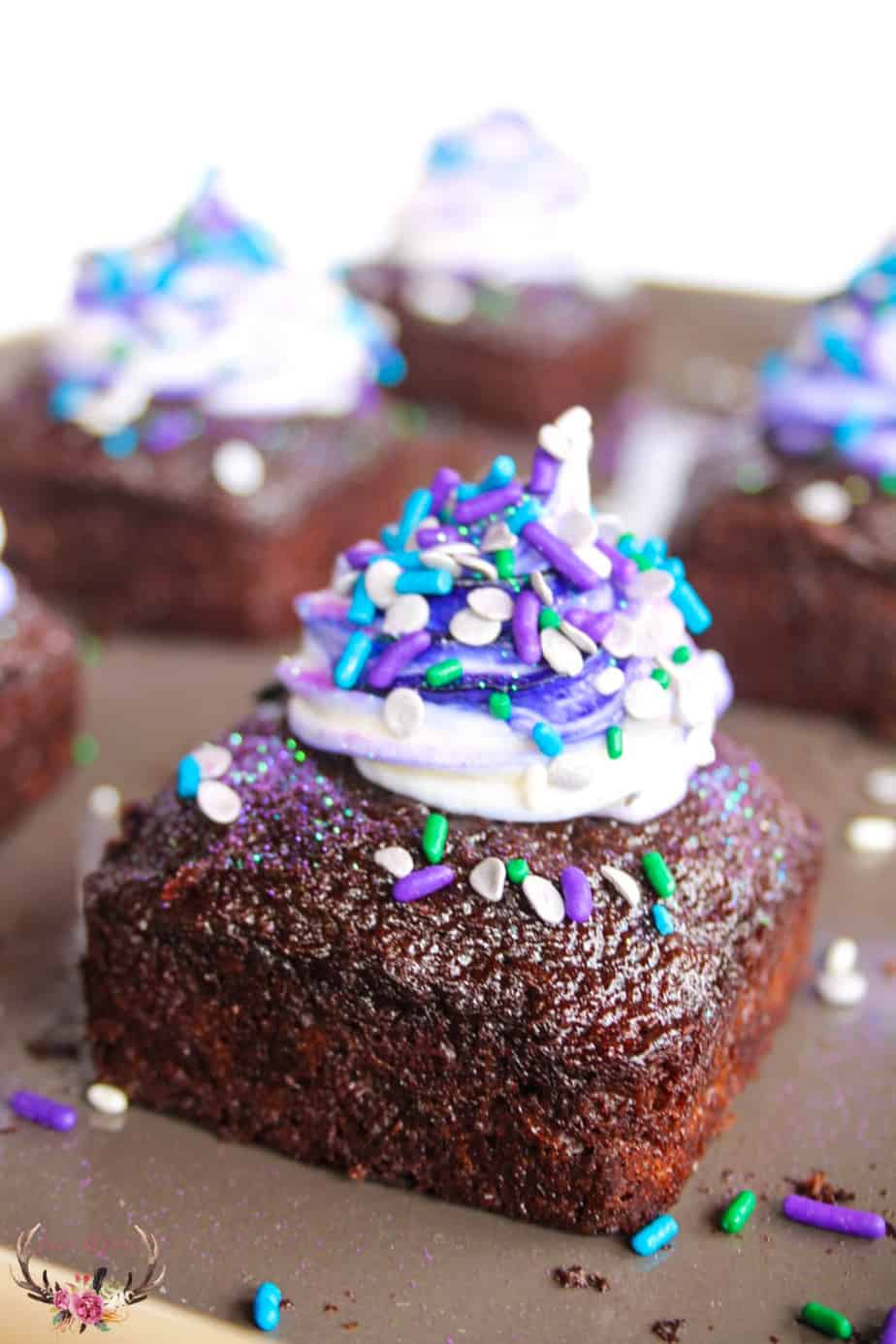 close up of chocolate cake with purple and white icing